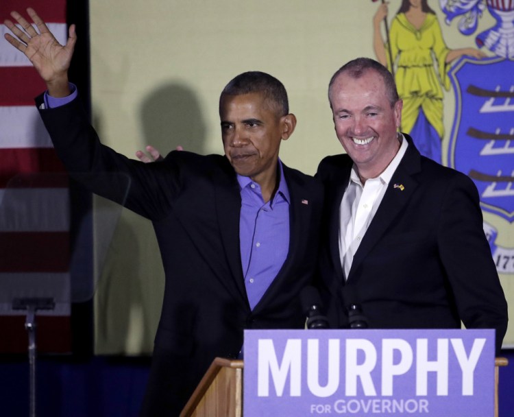 Former President Barack Obama and New Jersey Democratic gubernatorial nominee Phil Murphy stand on stage after Obama gave remarks during a canvassing event for Murphy last week in Newark, N.J.