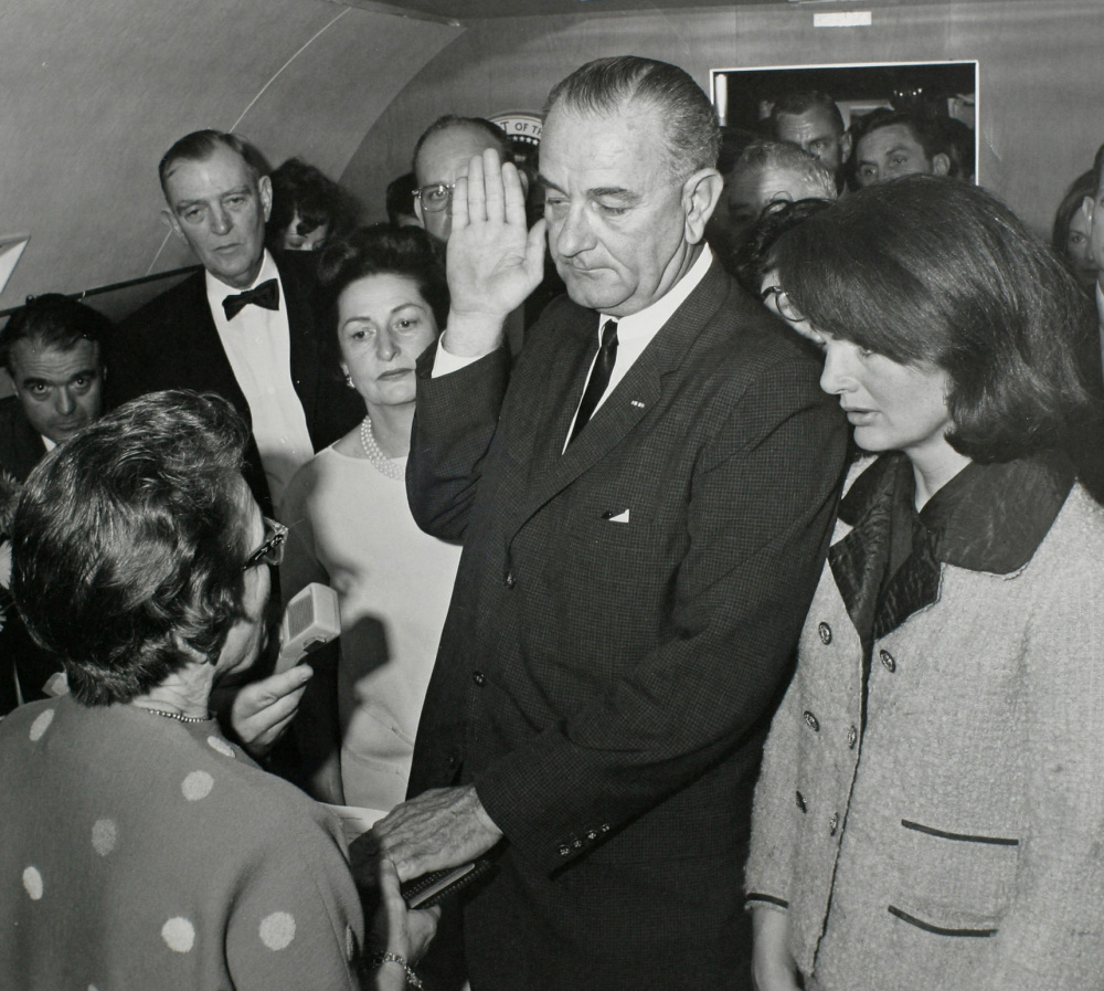 Vice President Lyndon Johnson takes the oath of office as President Kennedy's widow, first lady Jacqueline Kennedy, stands at his side. 