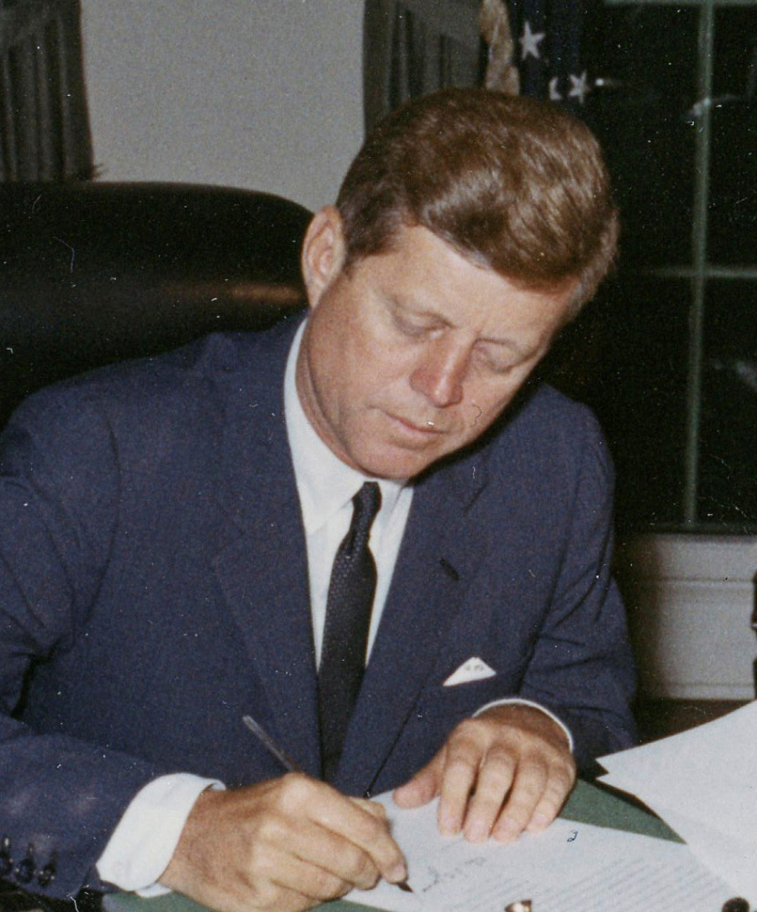 President Kennedy signs a proclamation during the Cuban missile crisis. 