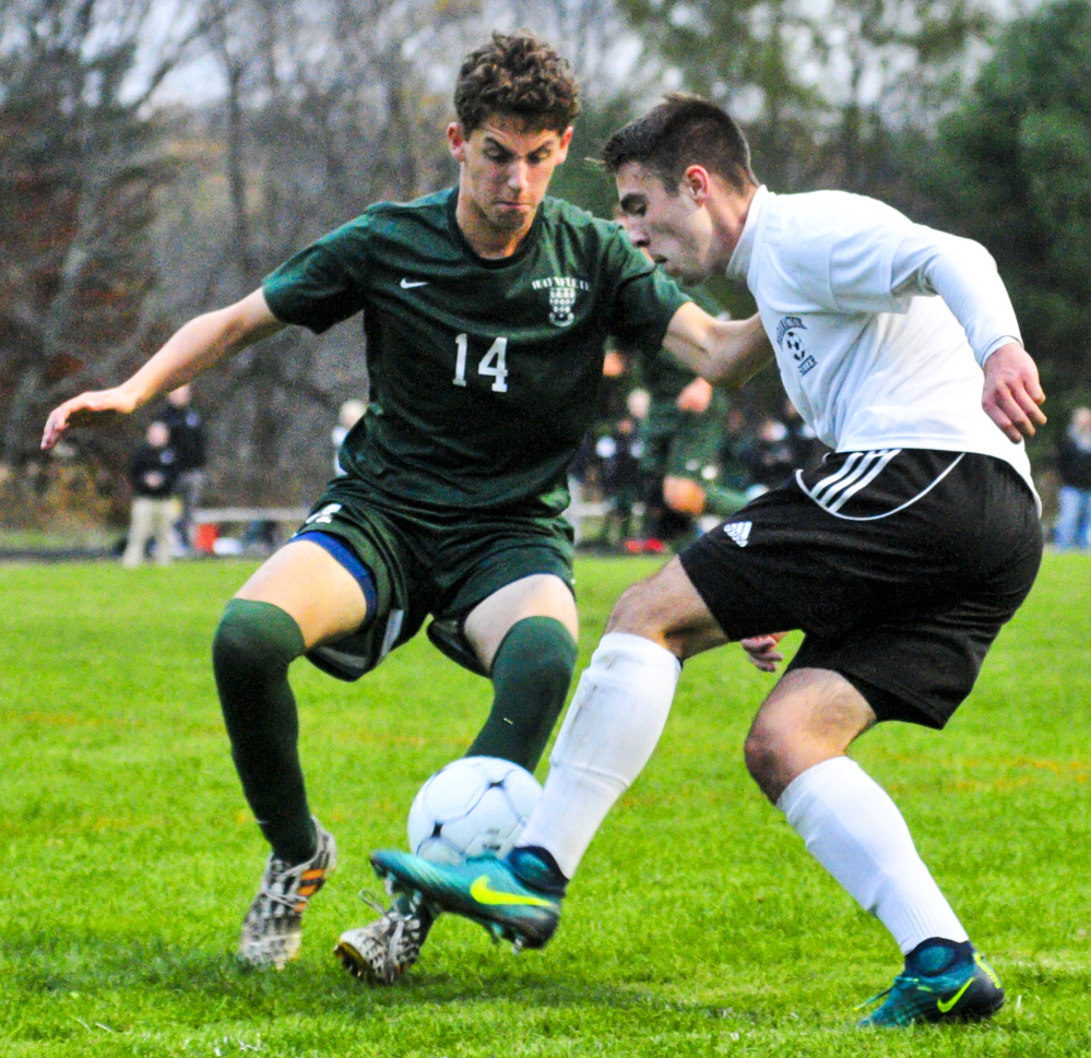Waynflete's Miles Lipton, left, and Maranacook's Micah Charette battle for the ball during their Class C South semifinal Saturday in Readfield. Maranacook won in double overtime, 2-1.