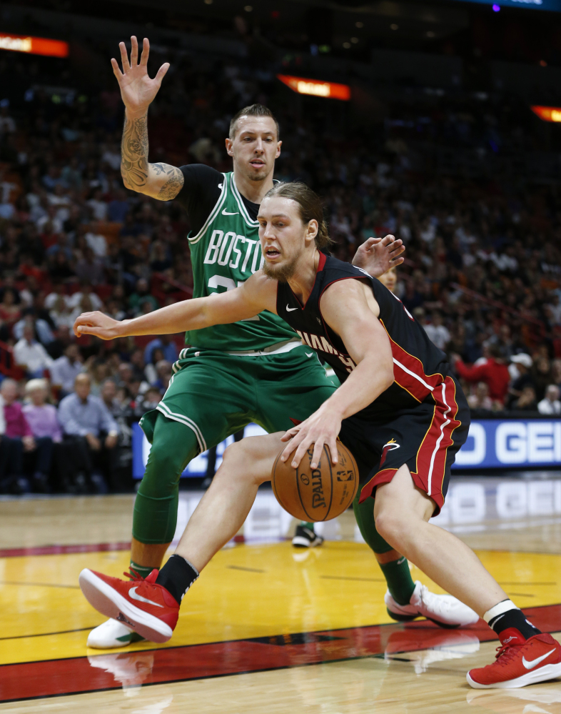 Heat forward Kelly Olynyk drives to the basket against Boston Celtics forward Daniel Theis during the first Saturday in Miami.