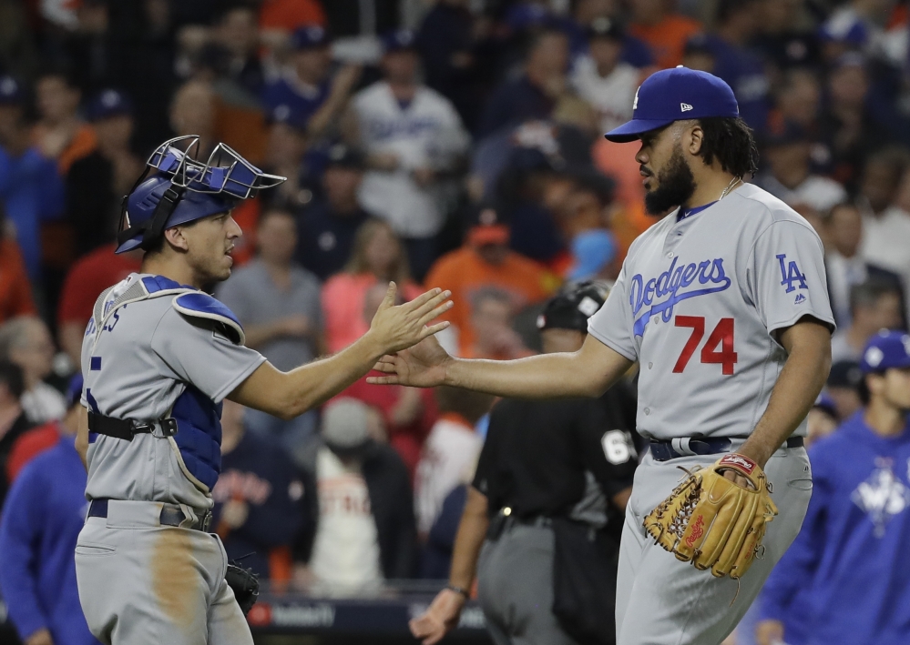 Los Angeles closer Kenley Jansen shakes hands with catcher Austin Barnes at the end of Game 4 of the World Series on Saturday night in Houston. The Dodgers won 6-2 to tie the series at 2.