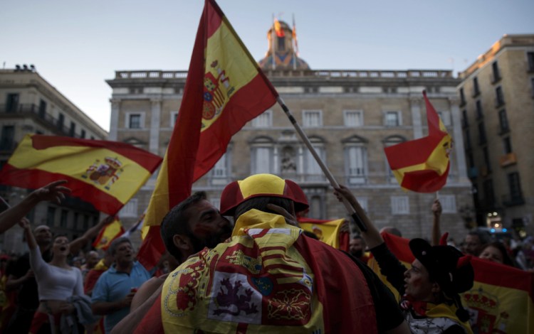 Pro-Spain union demonstrators dance after a rally against Catalonia's declaration of independence that drew hundreds of thousands in Barcelona, Spain, on Sunday.