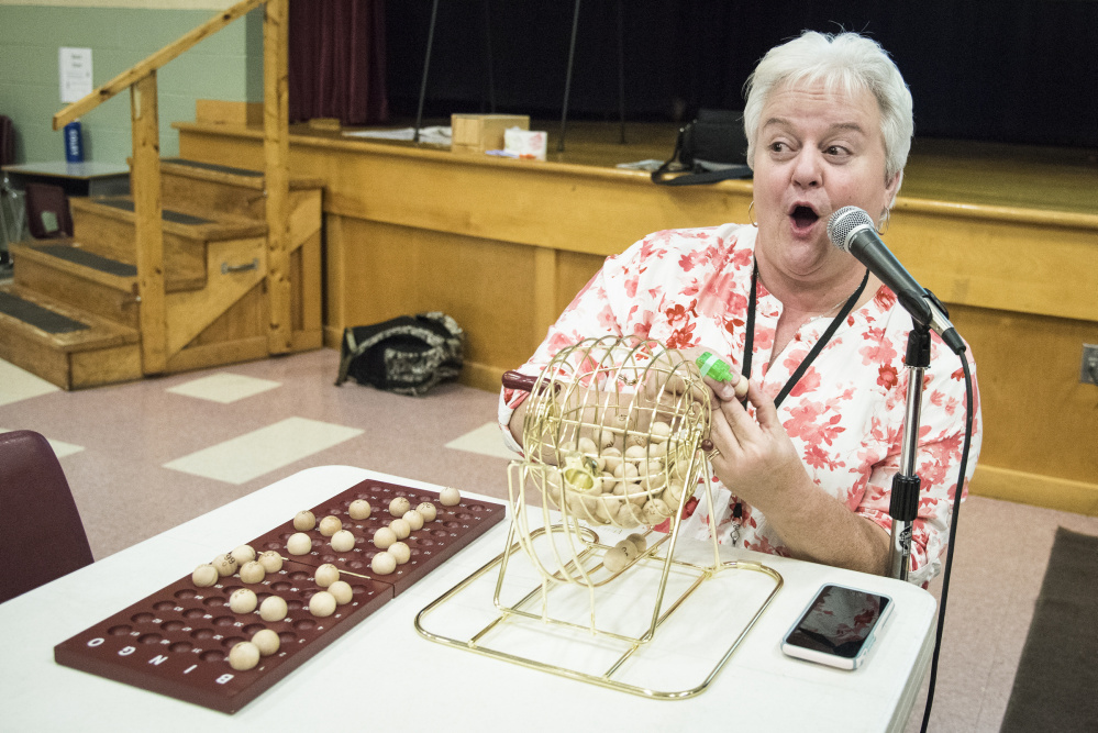 Winslow Elementary School teacher Patty Scully calls out numbers and letters at bingo night at the school Oct. 20. The fundraiser resumed following a change in state law.