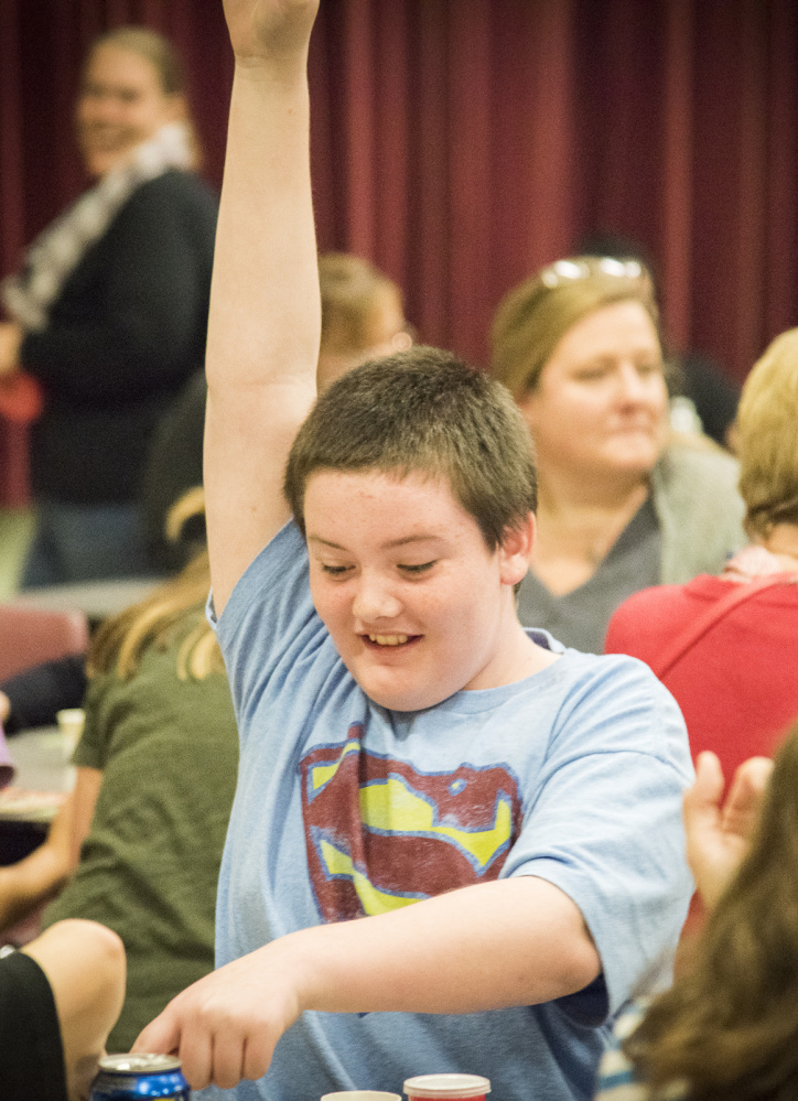 Hunter Ward, 11, of Winslow raises his hand indicating "bingo" at Winslow Elementary School.
