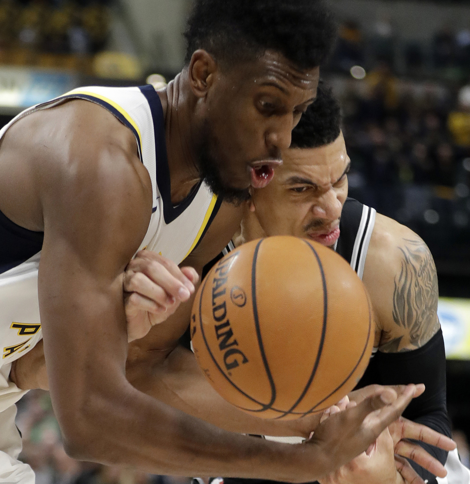 Indiana's Thaddeus Young, left, and San Antonio's Danny Green battle for the ball during the Pacers' 97-94 win Sunday in Indianapolis.