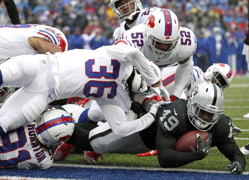 Raiders fullback Jamize Olawale dives into the end zone for a touchdown Sunday, giving Oakland an early lead that didn't last long, as Buffalo earned a 34-14 victory.