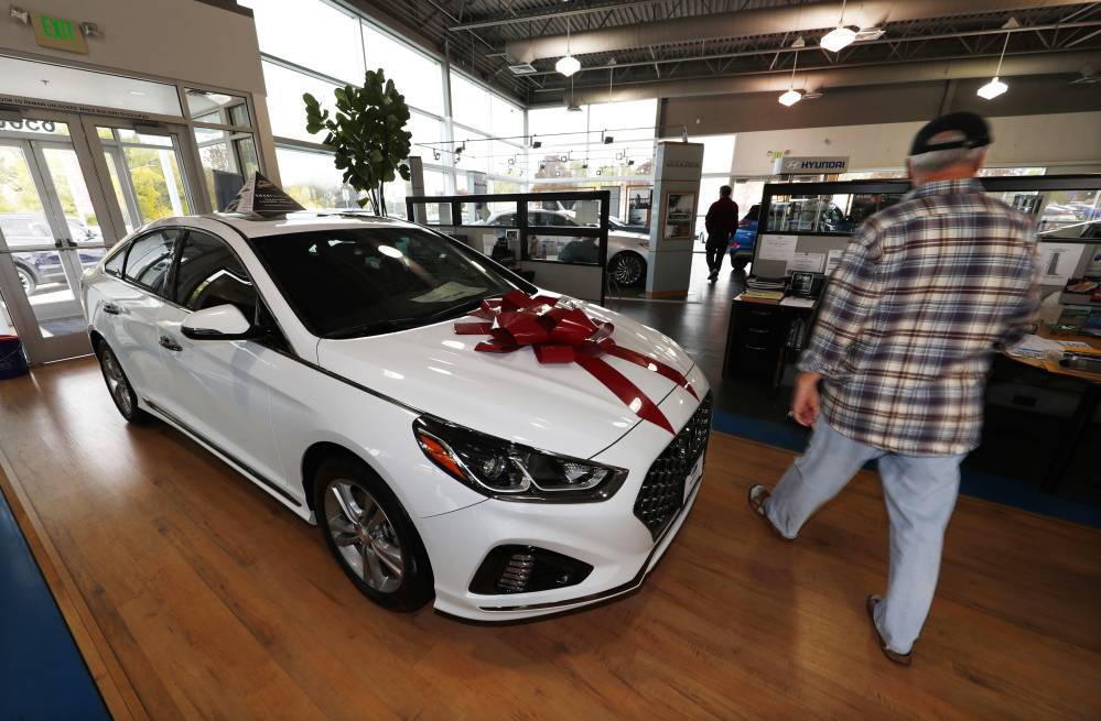 A buyer walks past a 2018 Sonata on the showroom floor of a Hyundai dealership in Littleton, Colo. The Commerce Department on Monday issued its September report on consumer spending, which accounts for roughly 70 percent of U.S. economic activity.