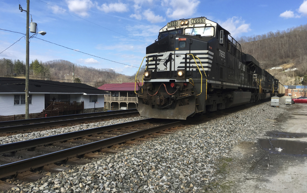 A Norfolk Southern coal train runs through Kermit, W.Va. Norfolk Southern Railway must replace millions of defective wooden railroad ties on its tracks because they're degrading faster than expected, the company said in a federal lawsuit filed in Alabama.