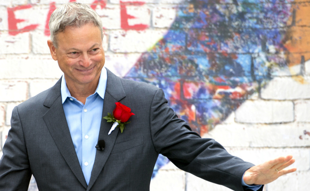 Actor Gary Sinise waves Monday after being named grand marshal of the 2018 Rose Parade. He was chosen for his many contributions to veterans' causes.