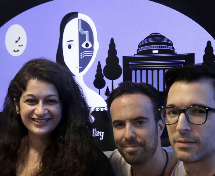 From left, MIT researchers Pinar Yanar- dag, Manuel Cebrian and Iyad Rahwan developed a "bot" that generates horror stories on Twitter. Behind them is a graphic from the website home page.