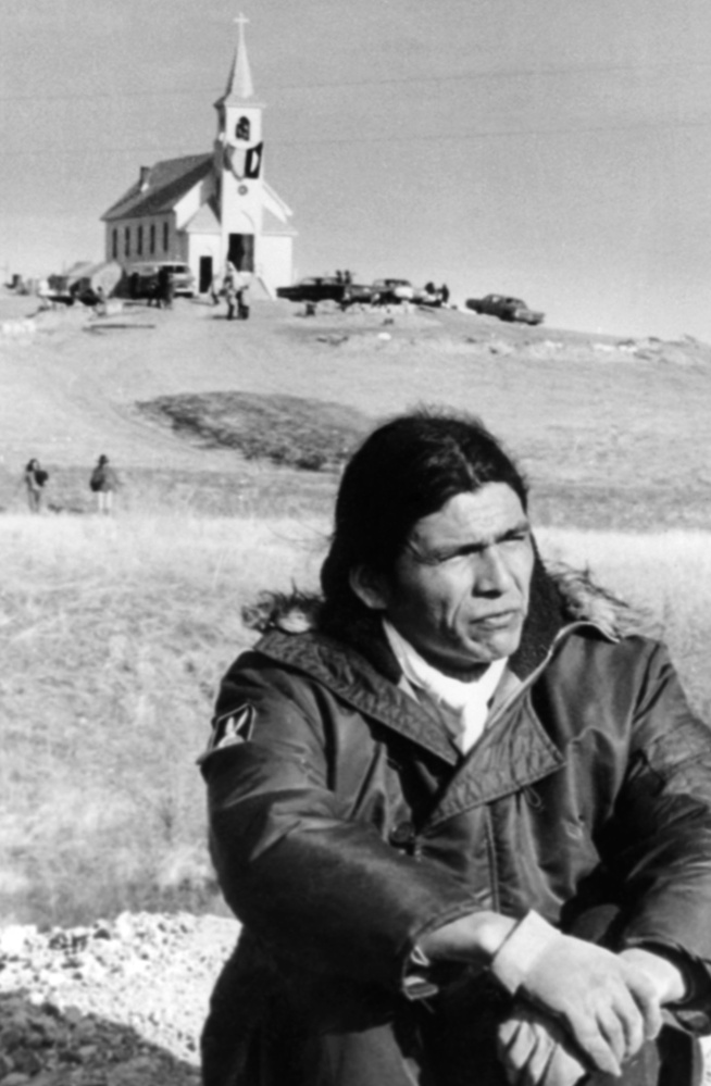 Dennis Banks sits in the open prairie on March 4, 1973, at Wounded Knee, S.D., where he led a protest against both the U.S. and tribal governments.