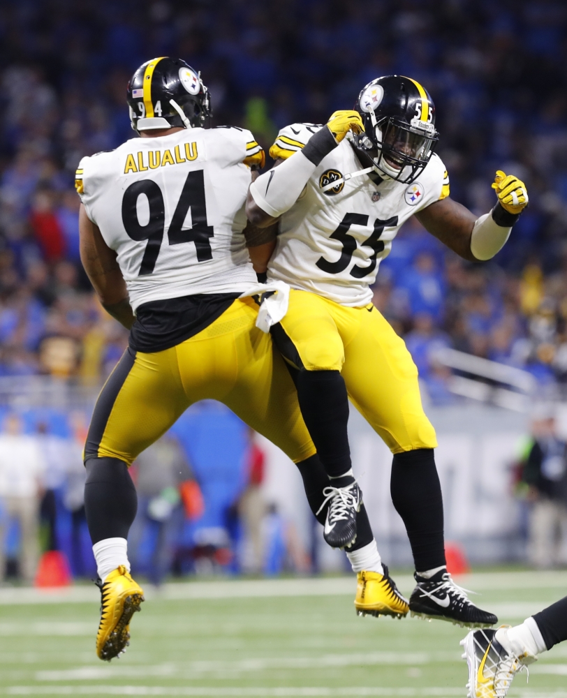 Steelers defenders Tyson Alualu, left, and Arthur Moats celebrate after teammate JuJu Smith-Schuster's record 97-yard TD reception Sunday.