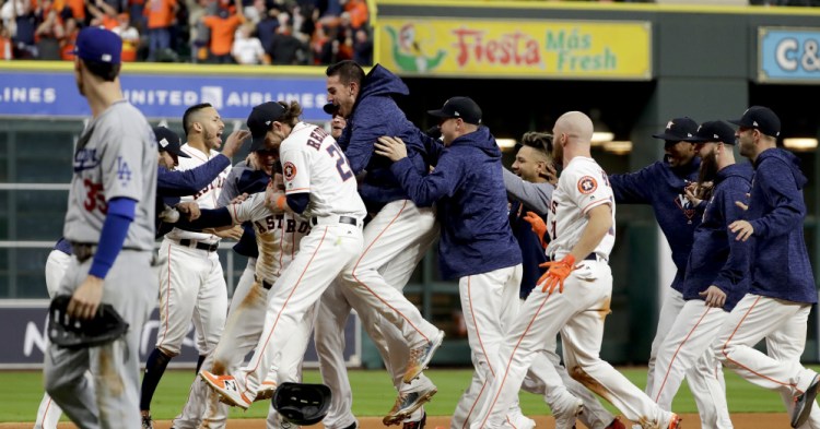 The Houston Astros celebrates after Alex Bregman's game-winning single in Game 5 of the World Series early Monday.