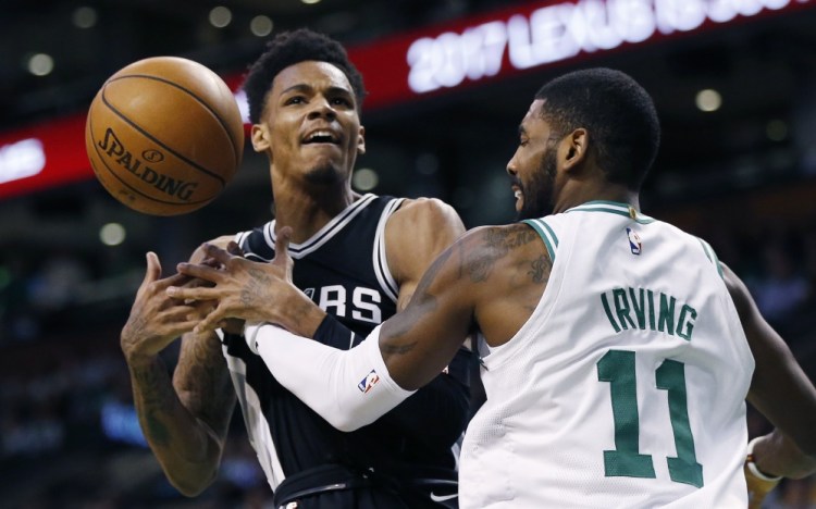 San Antonio's Dejounte Murray loses control of the ball under pressure from the Celtics' Kyrie Irving in the first quarter of Monday night's game in Boston.