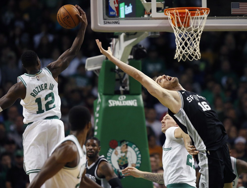 Boston's Terry Rozier grabs a rebound behind the Spurs' Pau Gasol in the third quarter. The Celtics went on to win, 108-94.