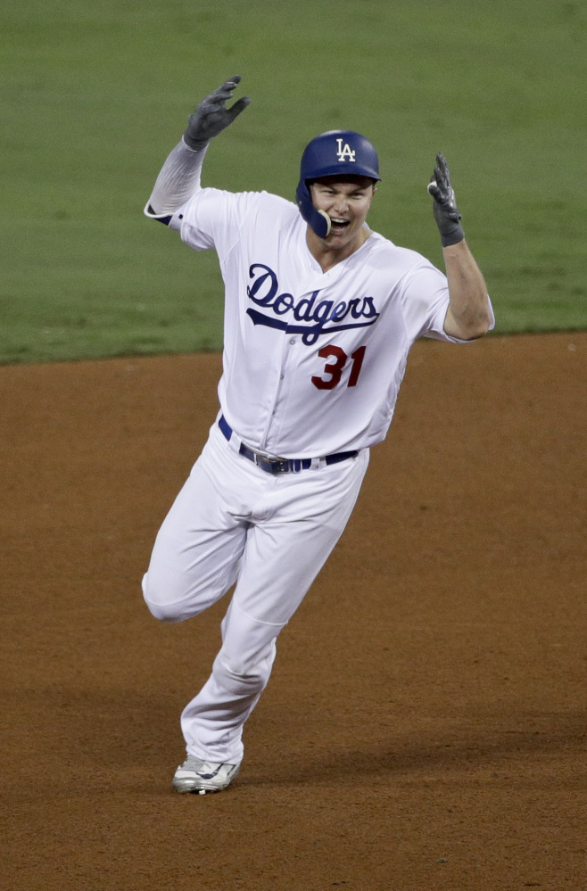 Los Angeles Dodgers' Joc Pederson celebrates his home run against the Houston Astros during the seventh inning of Game 6 Tuesday. Associated Press/Jae C. Hong