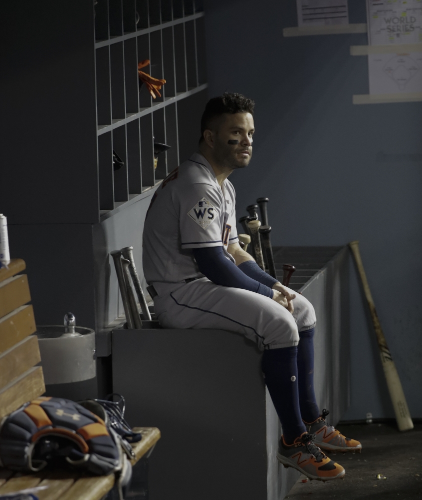 Houston Astros' Jose Altuve watches from the dugout during the eighth inning Tuesday. Associated Press/David J. Phillip