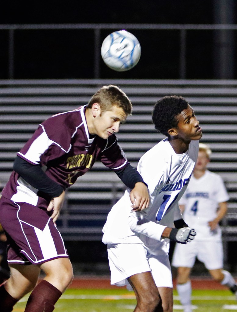 Thornton Academy's Jake Nason and Portland's Sam Nkurunziza go after a ball in the first half of Monday's game.