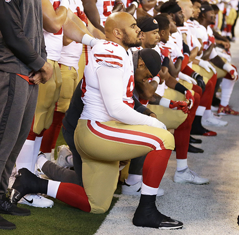 Members of the San Francisco 49ers kneel during the playing of the national anthem before an NFL football game against the Indianapolis Colts, Sunday, Oct. 8, 2017, in Indianapolis. 