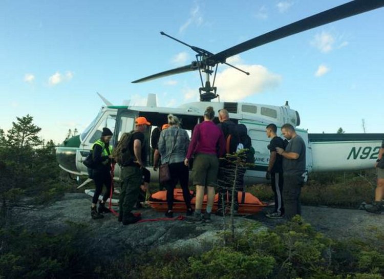 Rescuers carry Kelsey Lampher of Phoenix to a helicopter after she injured her ankle Tuesday while hiking the Appalachian Trail on Bemis Mountain in Township D in northern Franklin County.