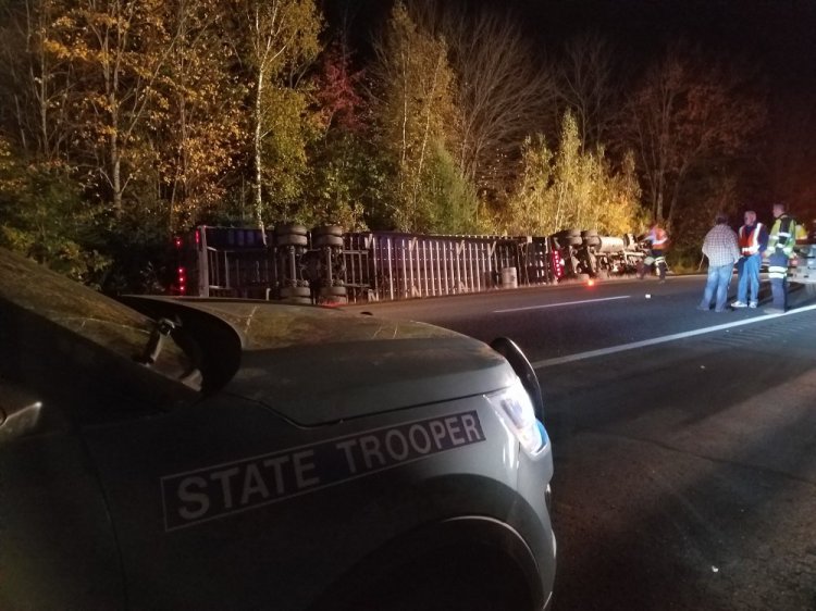A tractor trailer carrying a load of french fries rests on its side after crashing on I-95 Monday night. The driver was reportedly blinded by the setting sun and drove into the median ditch.