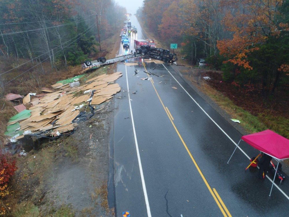 Photo courtesy of Maine State Police 
 Police and firefighters at the scene of a tractor trailer accident after the rig overturned and dumped building material on Route 3 near the Dirigo Road in China on Wednesday.