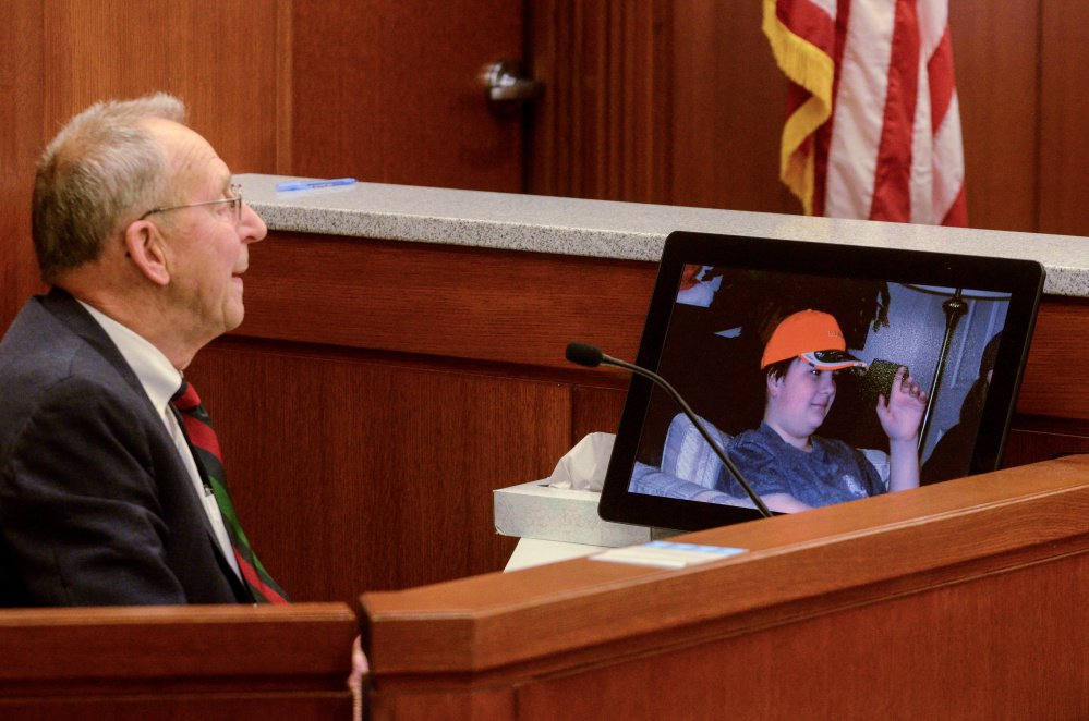 Andrew Balcer's grandfather Arthur Pierce, 82, looks at photo of Andrew during a hearing on Thursday in Augusta to determine whether Balcer should be tried as an adult for allegedly killing his parents.
