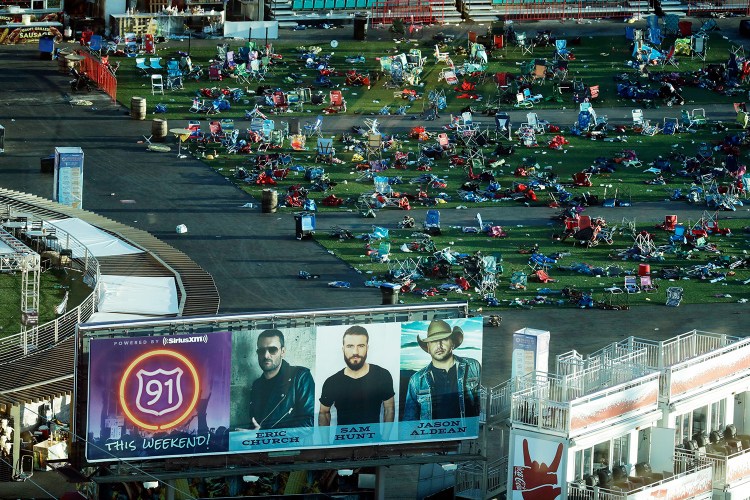 Debris litters a festival grounds across the street from the Mandalay Bay resort and casino Tuesday in Las Vegas. Authorities said Stephen Craig Paddock broke windows on the casino and began firing with a cache of weapons, killing dozens and injuring hundreds at a music festival at the grounds.  
