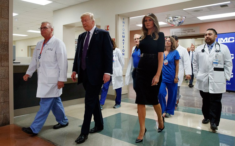 President Trump and first lady Melania Trump walk through University Medical Center in Las Vegas on Wednesday after meeting with people wounded in the mass shooting Sunday night.