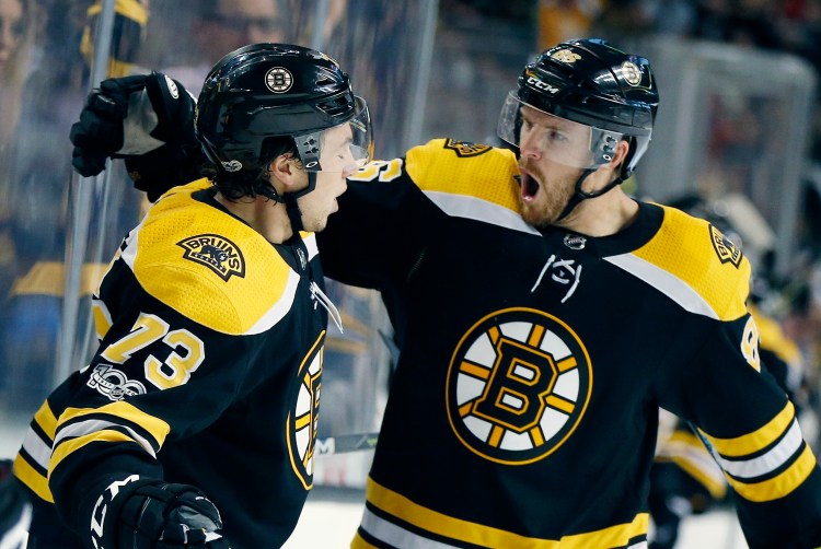 Boston's Charlie McAvoy, 73, celebrates his goal with Kevan Miller in the second second period Thursday night against the Predators in Boston. The Bruins won, 4-3.