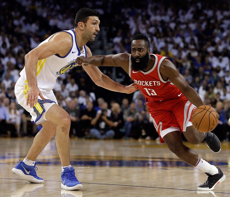 Houston's James Harden, right, drives the ball against Golden State's Zaza Pachulia during the first quarter of an NBA basketball game Tuesday.