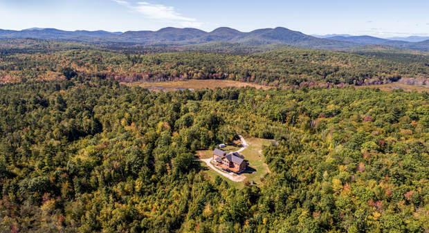 A view of the Brownfield property the Donlon family is bringing to an upscale auction next month. They spent 26 months hand-building the 6,000-square-foot red cedar log cabin at the center of 173 acres.