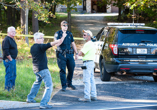 Michael Koch, center, explains to Auburn Police Officer Thomas Ellis how he found his sister tied up at her home on Park Avenue in Auburn Thursday afternoon after she came home to find two people burglarizing her home.