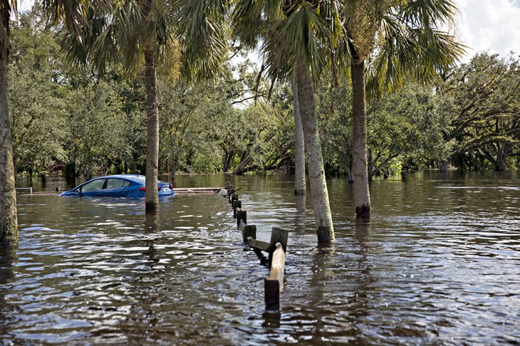 A car sits submerged in floodwaters along a road in Buckingham, Florida, on Sept. 12, 2017.