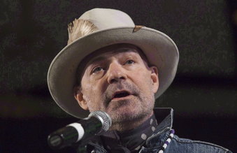In this Dec. 6, 2016 photo, Gord Downie speaks during a ceremony honoring him at the AFN Special Chiefs assembly in Gatineau, Quebec.  Downie, the poetic lead singer of the Tragically Hip whose determined fight with brain cancer inspired a nation, has died. He was 53.  