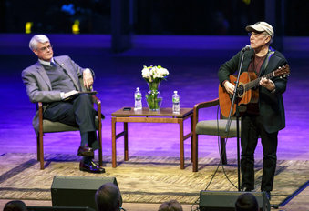Grammy winning recording artist Paul Simon performs a song at Skidmore College in Saratoga Springs, N.Y. The singer-songwriter visited the college to participate in a master class about songwriting, followed by an event titled "Paul Simon: A Conversation about a Musical Life." At left is Skidmore President Philip A. Glotzbach. 