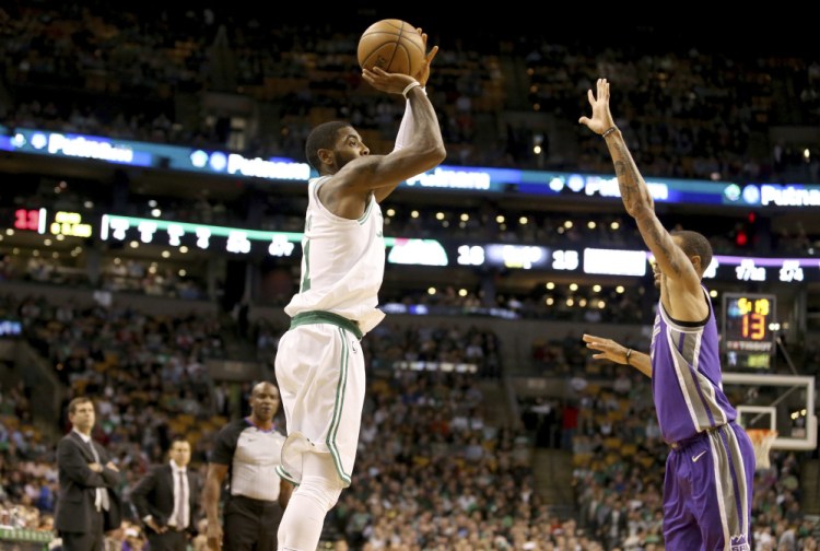 Boston's Kyrie Irving shoots over Sacramento's George Hill in the first half Wednesday night in Boston.