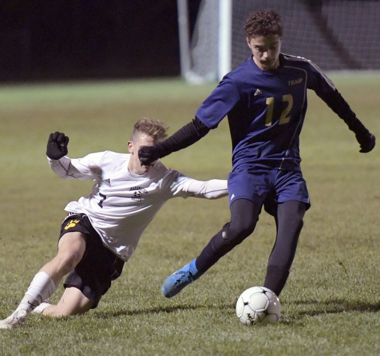 Maranacook's Mitchell Root, left, tries to defend Traip Academy's Ryan Perkins during the Class C South championship game Wednesday in Readfield. The Black Bears won 3-0 to move on to the state final.