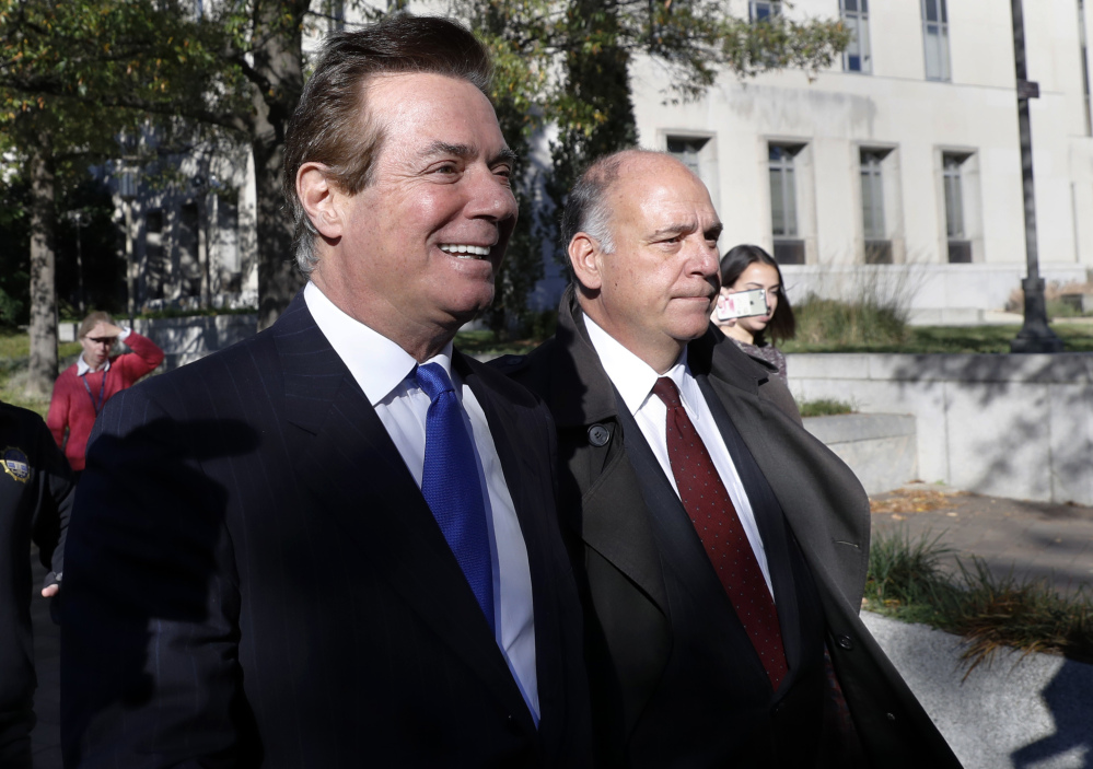 Paul Manafort, left, leaves Federal District Court in Washington on Monday. Manafort, President Trump's former campaign chairman, and Manafort's business associate Rick Gates pleaded not guilty to felony charges of conspiracy against the United States and other counts.
