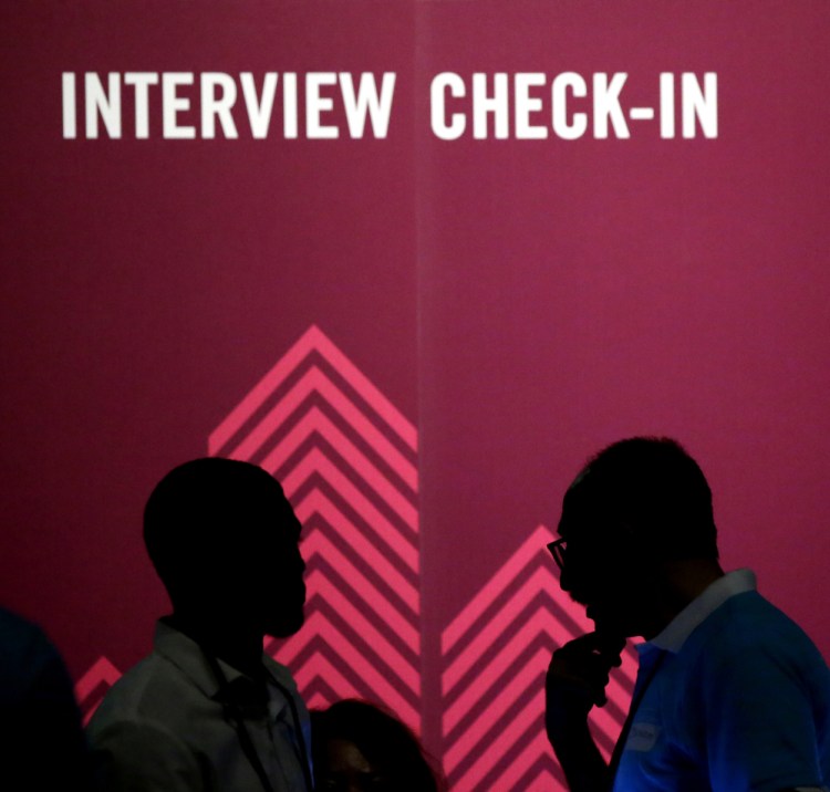 Job seekers chat during an Opportunity Fair and Forum employment event in Dallas. A poll found that half of U.S. job applicants have been asked inappropriate questions.