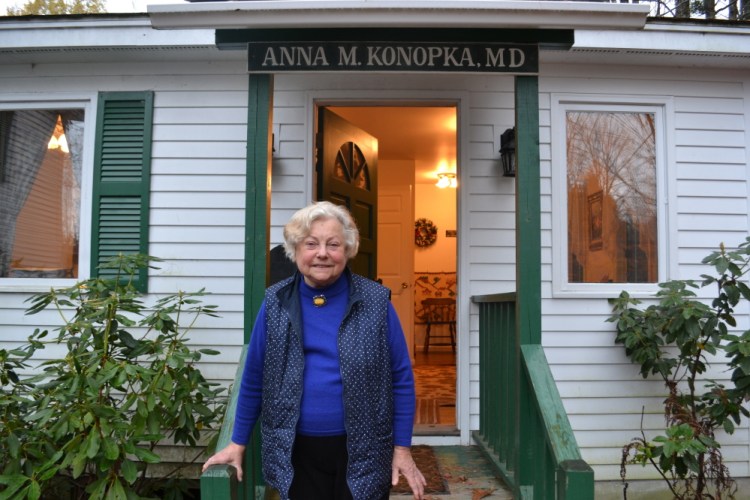 Dr. Anna Konopka stands in front of her tiny office in New London, N.H.