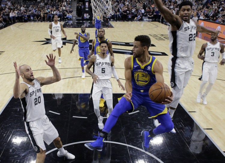 Golden State Warriors guard Stephen Curry (30) drives to the basket against the San Antonio Spurs during the first half of an NBA basketball game, Thursday, Nov. 2, 2017, in San Antonio. (AP Photo/Eric Gay)