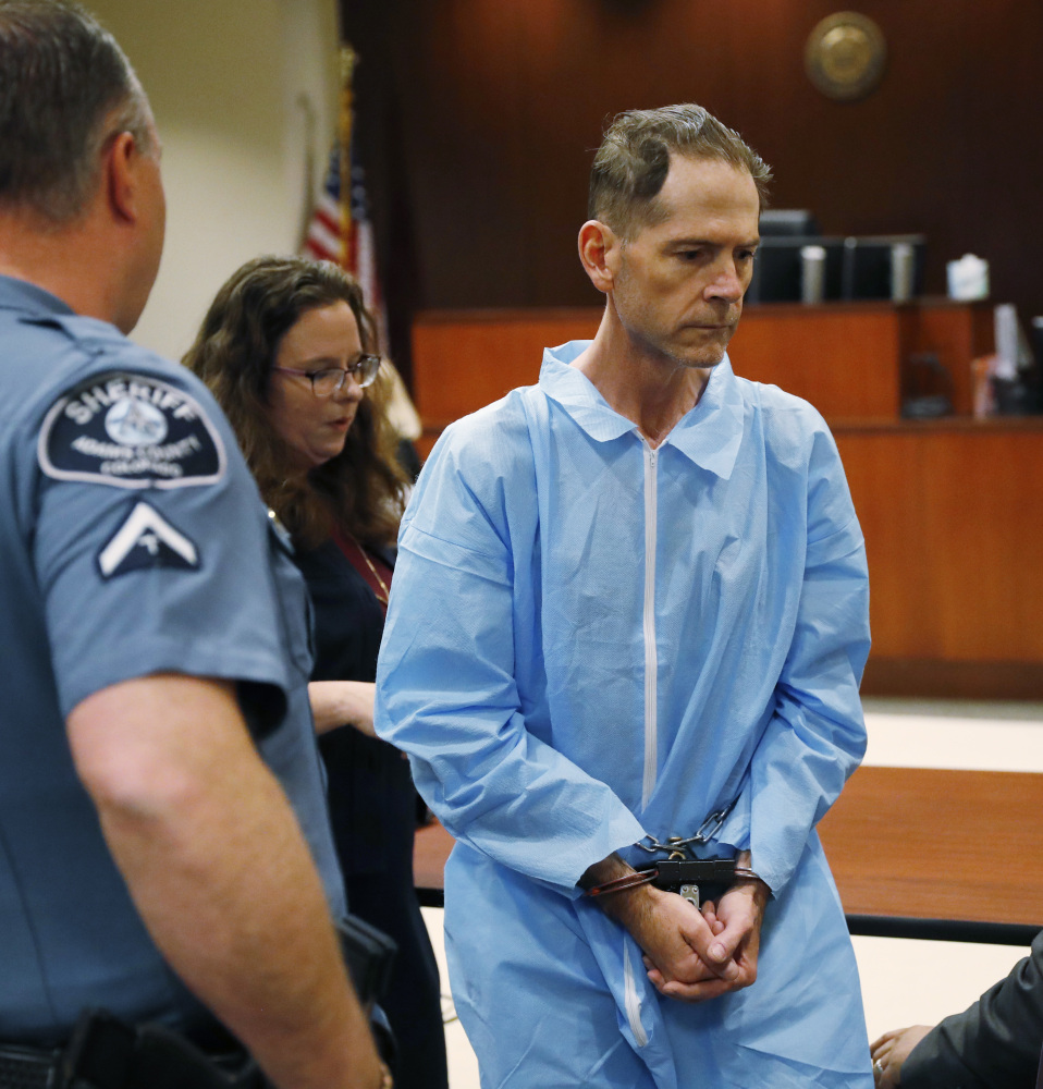Scott Ostrem, 47, center, leaves a hearing in an Adams County, Colo., court on  Friday in Brighton, Colo. Ostrem is the suspect in the killing of three shoppers inside a Thornton, Colo., Walmart store Wednesday.