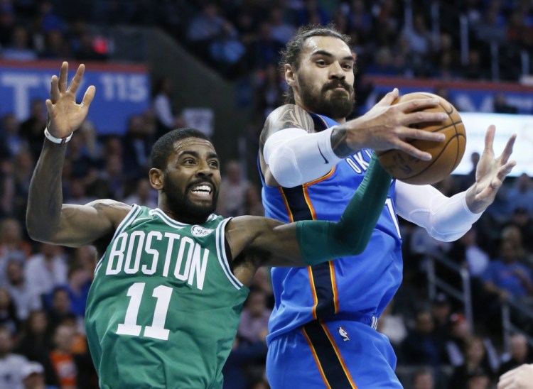 Oklahoma City's Steven Adams grabs a rebound in front of Boston's Kyrie Irving in the first quarter of Friday night's game at Oklahoma City.