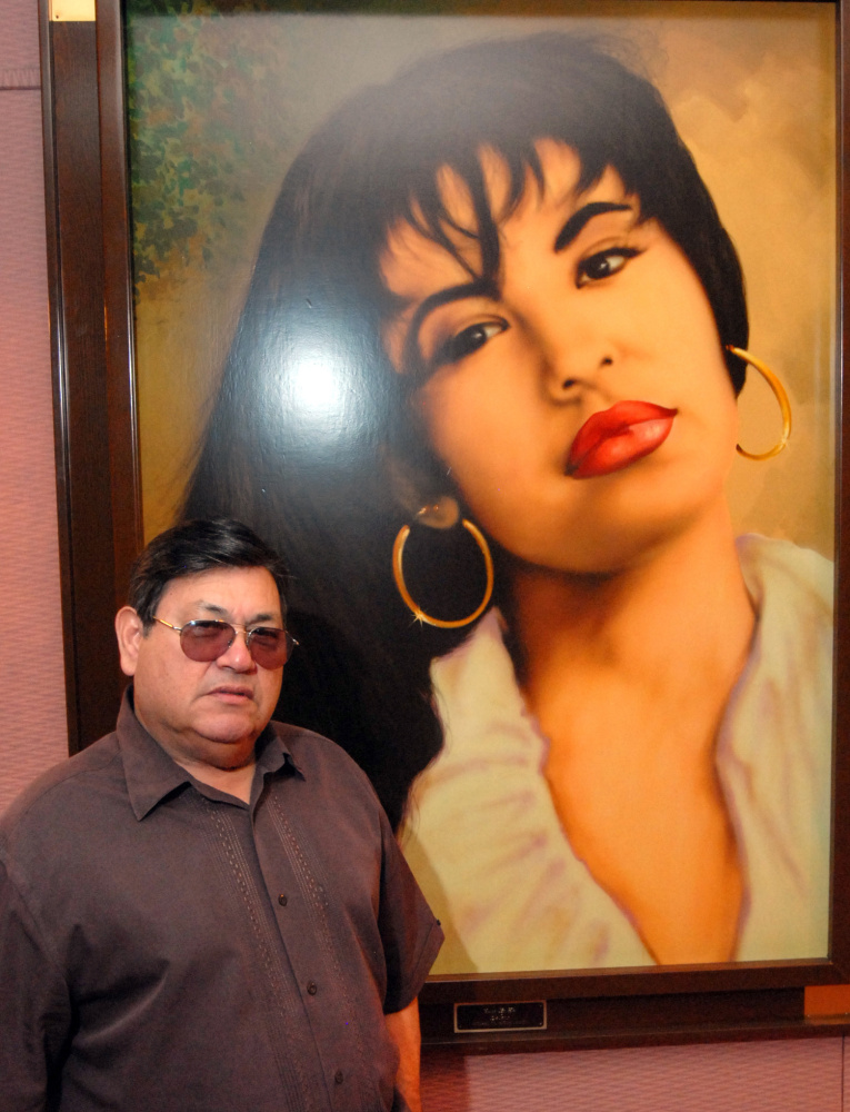 Abraham Quintanilla, father of the late Selena, poses in front of an airbrush work of the singer in 2011.