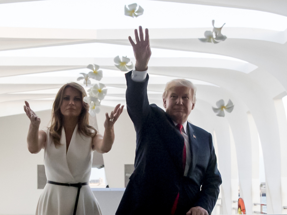 President Trump and first lady Melania Trump throw flower petals while visiting the Pearl Harbor Memorial in Honolulu on Friday. Next stop: Japan, and golf with Prime Minister Abe.
(AP Photo