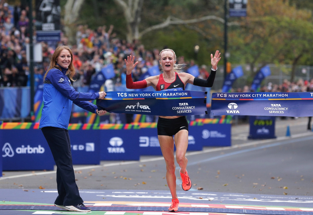 Shalane Flanagan crosses the finish line first in the women's division of the New York City Marathon on Sunday.