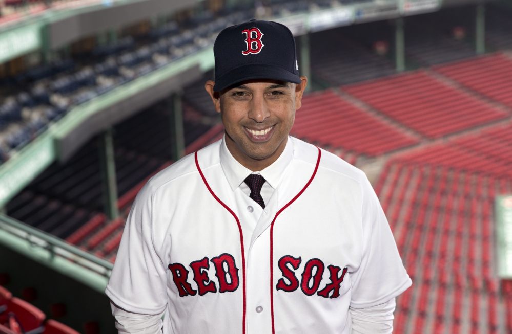 New Boston manager Alex Cora poses in Fenway Park on Nov. 6 after the news conference at which the team introduced him. Cora, who's 42, and Aaron Boone, 44, are now the leaders of the rival Red Sox and Yankees.