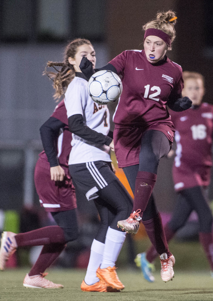Staff photo by Michael G. Seamans 
 Richmond's Ashley Brown (12) battles for the ball with Ashland's Danni Carter (1) in the Class D state championship game Saturday in Hampden.